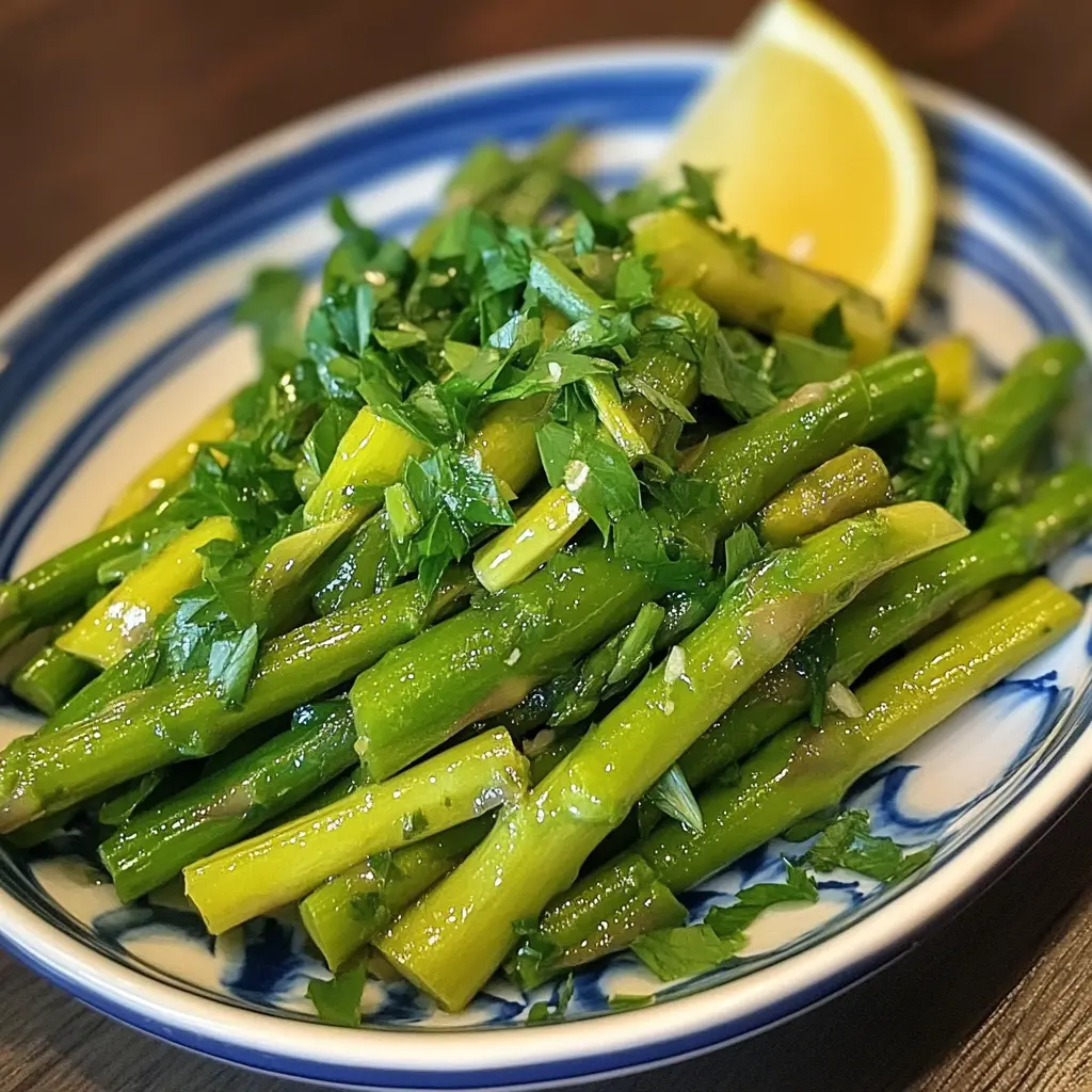 Vibrant plate of sautéed asparagus garnished with freshly squeezed lemon juice.