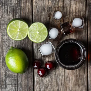Ingredients for Taco Bell Baja Midnight drink: Baja Blast soda, cherry syrup, lime, and ice cubes, arranged on a wooden surface