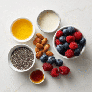Ingredients for chia seed pudding: chia seeds, almond milk, honey, and berries